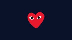 a red heart with two eyes on a black background