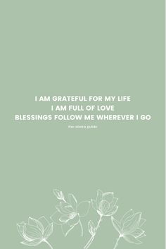 a green background with white flowers and the words, i am grateful for my life