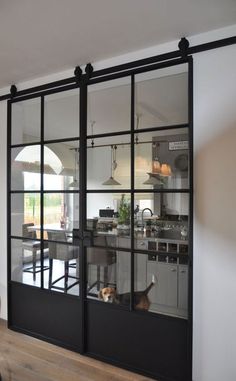 an open kitchen and dining room with sliding glass doors