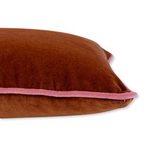 a brown and pink pillow on a white background with a light pink stripe down the side