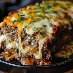 a close up of a plate of food with meat and cheese on the top,