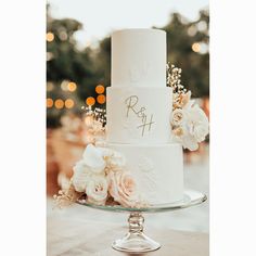 a white wedding cake with flowers on top