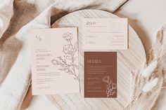 the wedding stationery is laid out on a plate