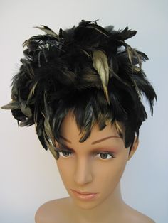 "* This fascinator features coal black 6-7\" feathers all tipped in gold. Perfect for fall and winter and with the spider fantastic for Halloween or a costume party. If desired, you can remove the spider. * A generous supply of feathers create a feminine look and allows any slight breeze to create a flutter adding motion and sophistication to the design. * On a black satin covered acrylic headband the design is secure, evenly balanced and on trend with the gold tipping. Try it on front to back a Black Feathered Headpiece For Costume, Black Ostrich Feather Headpiece, Black Ostrich Feather Trim Headpiece, Feathered Hats And Headpieces For Halloween Costume Party, Black Feather Trim Costume Hats For Party, Feathered Costume Hats And Headpieces For Halloween, Black Feather Trim Party Hat, Black Feathered Costume Accessories For Costume Party, Feathered Halloween Party Costume Accessories