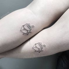 two people with matching tattoos on their arms