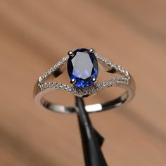 It is lab sapphire ring, the main stone is about 6mm*8mm, oval cut, weight about 1.75 carats.The basic metal is sterling silver and plated with rhodium.To change the metal to a solid gold (white/rose) or platinum is also available, please ask for a quotation if you want.You can also go to my shop Home for more elegant rings: https://www.etsy.com/shop/godjewelry?ref=hdr_shop_menuSapphire  is September  birthstone.More lab sapphire rings:https://www.etsy.com/shop/godjewelry?ref=seller-platform-mcn Rainbow Topaz Ring, September Birthstone Ring, Elegant Rings, Sapphire Diamond Engagement, September Birthstone Rings, Ring Sapphire, Fancy Rings, Blue Sapphire Ring, Blue Sapphire Diamond