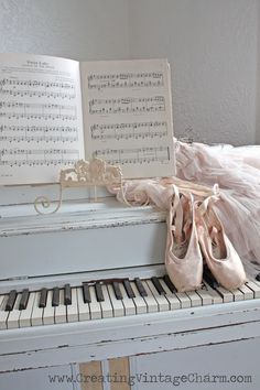 a pair of ballet shoes sitting on top of a piano