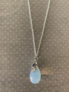 "Lovely moonstone white teardrop shaped necklace featuring silver tone regal motif with purple inlaid gem stone. Pendant measures 7/8\" L X 1/2\" W and is on an 18\" chain. Note: This is a slightly smaller version of this necklace sold prior to 6/30/20. Also available with a black stone under the following listing: https://www.etsy.com/listing/858843851/moonstone-necklace-moon-stone-necklace?ref=listings_manager_grid ★ Want to see more? Please visit my shop at: https://www.etsy.com/shop/DesignsB Purple Gemstone Necklace, Moonstone Necklace Pendants, Moon Stone Jewelry, Moon Stone Necklace, Gem Stone Pendant, Gem Stone Necklace, Purple Stone Necklace, Crystal Necklace Silver, Purple Pendant