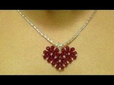 a woman wearing a red heart shaped necklace