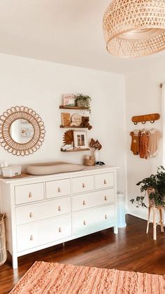 a baby crib in the corner of a room with lots of furniture and decor