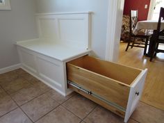 a white bench sitting on top of a wooden floor