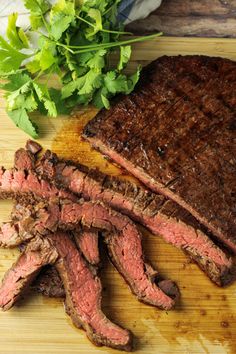 steak and parsley on cutting board with knife