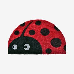 a red and black ladybug rug with eyes