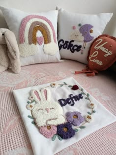 two pillows and some stuffed animals on a bed