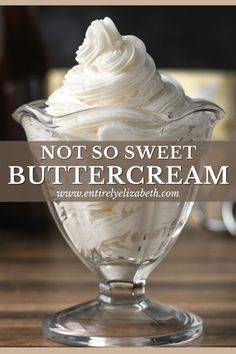 a glass bowl filled with whipped cream on top of a wooden table