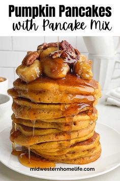 stack of pumpkin pancakes with syrup and pecans on top, in front of a white background