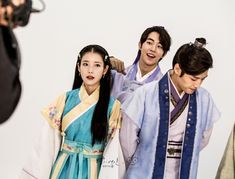 the actors are posing for pictures in their traditional costumes and hair accessories as they stand together