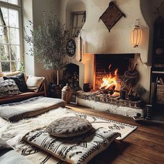 a living room filled with furniture and a fire place in the middle of the room