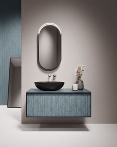 a bathroom with a sink, mirror and vase