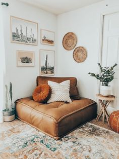 a living room filled with furniture and pictures on the wall