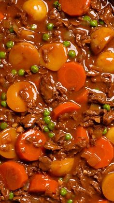 beef and carrots are in a brown gravy, with peas on the side