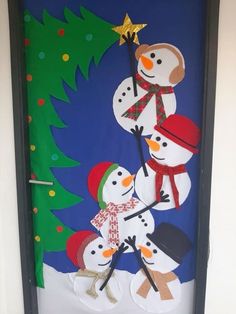 a door decorated with snowmen and a christmas tree