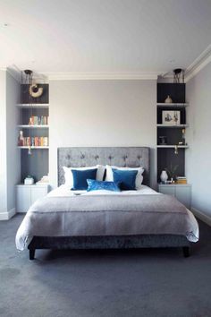 a large bed sitting in a bedroom next to a book shelf