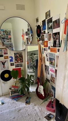 a room with various items and pictures on the wall, as well as a guitar