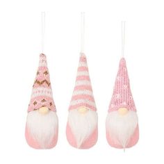 three pink and white gnome ornaments hanging from strings