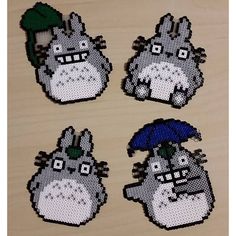 four pieces of pixelated totoro with an umbrella