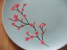 a white plate with pink flowers painted on it