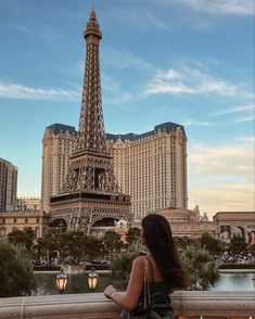 a woman looking at the eiffel tower in paris