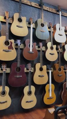 many guitars are hanging on the wall