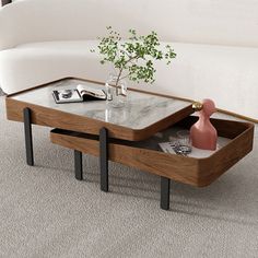 a coffee table with two trays on it in front of a white couch and grey carpet