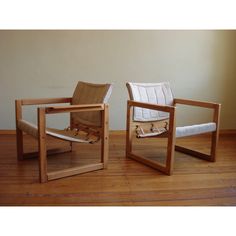 two wooden chairs sitting on top of a hard wood floor