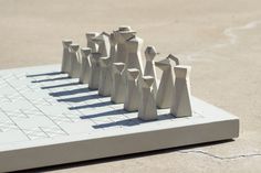 a chess board with white figures on it