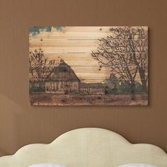 a bed in a room with a painting on the wall above it and a white headboard