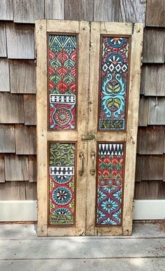 an old wooden door with colorful designs painted on it