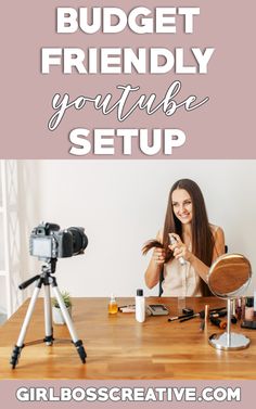 a woman sitting at a table with a camera in front of her and the words budget friendly youtube video setup