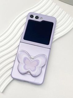 a cell phone with a butterfly sticker on the back of it's case