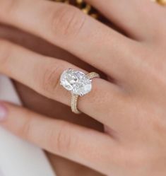 a woman's hand with a ring on her finger and a diamond in the middle