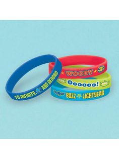 three wristbands that say woody and buzz lightyear are on a blue background