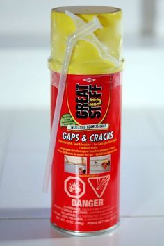 a can of gaps and crackers sitting on a white counter top with a straw sticking out of it