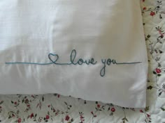 a pillow with the word i love you embroidered on it