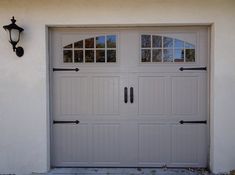 a white garage door with two windows on the side