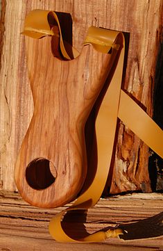 a piece of wood that has been made to look like a guitar case and strap