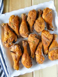 chicken wings are arranged on a white platter