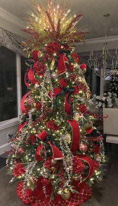 a decorated christmas tree with red bows and lights