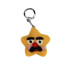 a star shaped keychain with a face on it