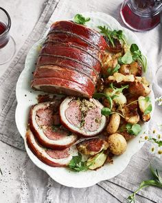 a white plate topped with meat and potatoes